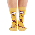 Person standing, wearing mustard yellow crew socks with flying squirrel pattern, viewed from the front.