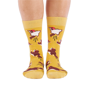Person standing, wearing mustard yellow crew socks with flying squirrel pattern, viewed from the front.