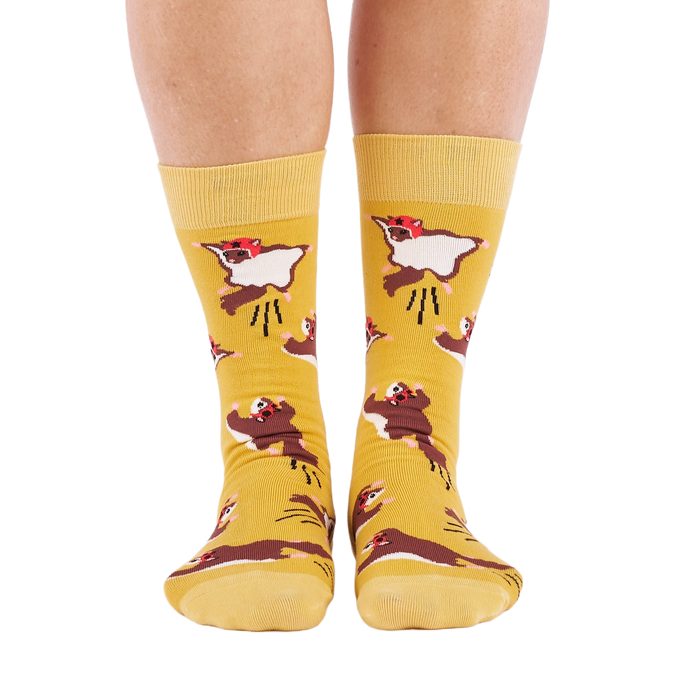 Person standing, wearing mustard yellow crew socks with flying squirrel pattern, viewed from the front.