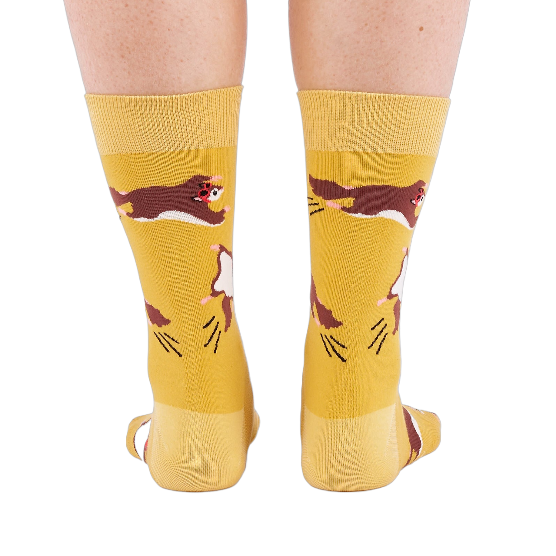 Person standing, wearing mustard yellow crew socks with flying squirrel pattern, viewed from the back.