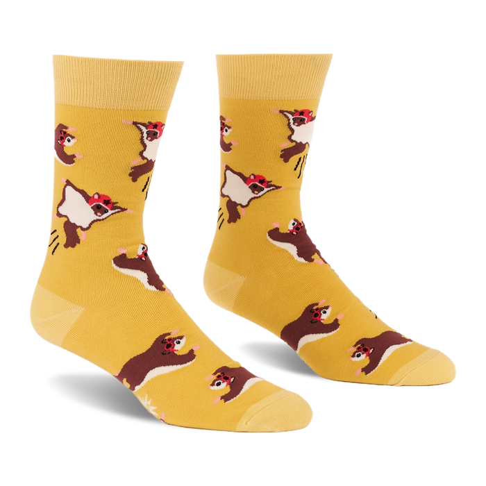 Pair of crew socks in mustard yellow with an all-over pattern of brown and white flying squirrels wearing red caps, shown against a white background.