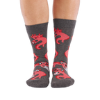 Full-length shot of a person's legs, viewed from the front, wearing grey axolotl gaming crew socks on a white background.