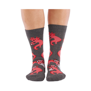 Full-length shot of a person's legs, viewed from the front, wearing grey axolotl gaming crew socks on a white background.
