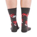 Full-length shot of a person's legs, viewed from the back, wearing grey axolotl gaming crew socks on a white background.