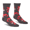 Pair of grey crew socks with a repeating pattern of coral pink axolotls holding game controllers and smartphones.