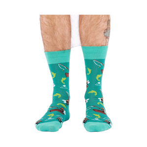 Front view of a person wearing teal fly fishing socks, showing leg hair and a partial tattoo on the right calf.