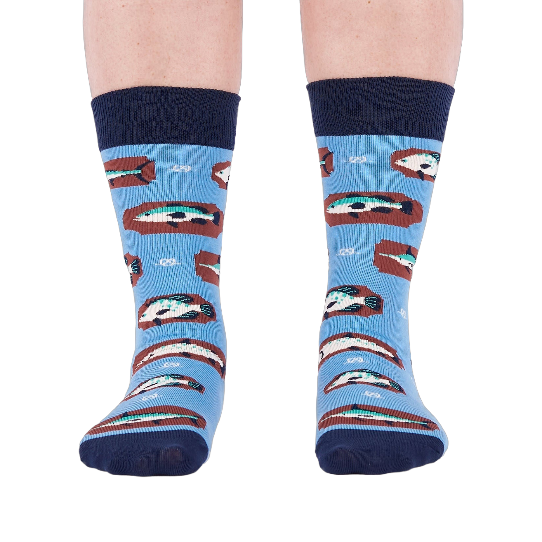 Person standing forward wearing light blue crew socks with fish and knot patterns on a white background.