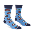 Pair of light blue crew socks with a repeating pattern of fish on brown rectangular shapes and white knot designs.