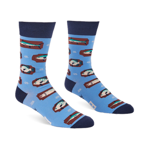 Pair of light blue crew socks with a repeating pattern of fish on brown rectangular shapes and white knot designs.