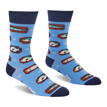 Pair of light blue crew socks with a repeating pattern of fish on brown rectangular shapes and white knot designs.