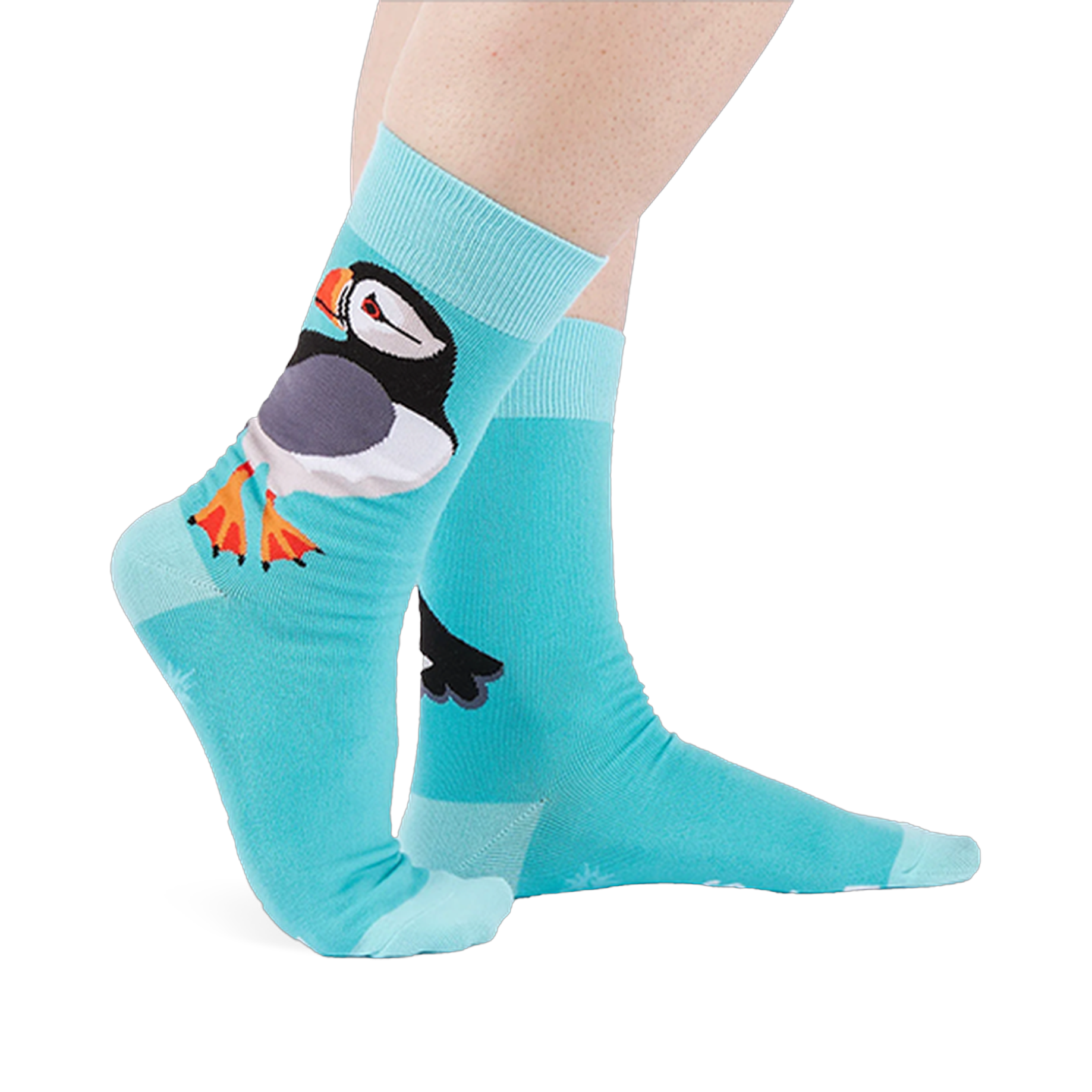 Person wearing light blue socks showing a large puffin on the ankle with an orange beak and white starbursts near the sole.