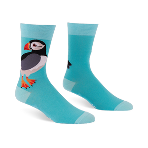 Light blue crew socks featuring a large puffin with a black back, white belly, and orange beak, with lighter blue cuffs.