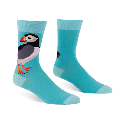 Light blue crew socks featuring a large puffin with a black back, white belly, and orange beak, with lighter blue cuffs.