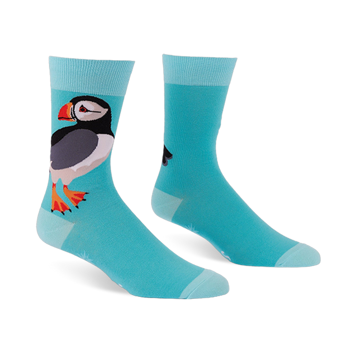Light blue crew socks featuring a large puffin with a black back, white belly, and orange beak, with lighter blue cuffs.
