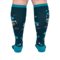 Back view of calves wearing dark teal knee-high socks, showing colorful music notes, pink roses, and blue ticket graphics.