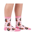 A person's lower legs wearing the light pink musical cat crew socks, shown from the side against a white background.