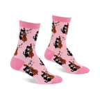 Pair of light pink crew socks with a repeating pattern of black cats playing string instruments, pink hearts, and music notes.