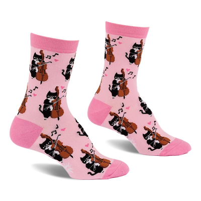 Pair of light pink crew socks with a repeating pattern of black cats playing string instruments, pink hearts, and music notes.