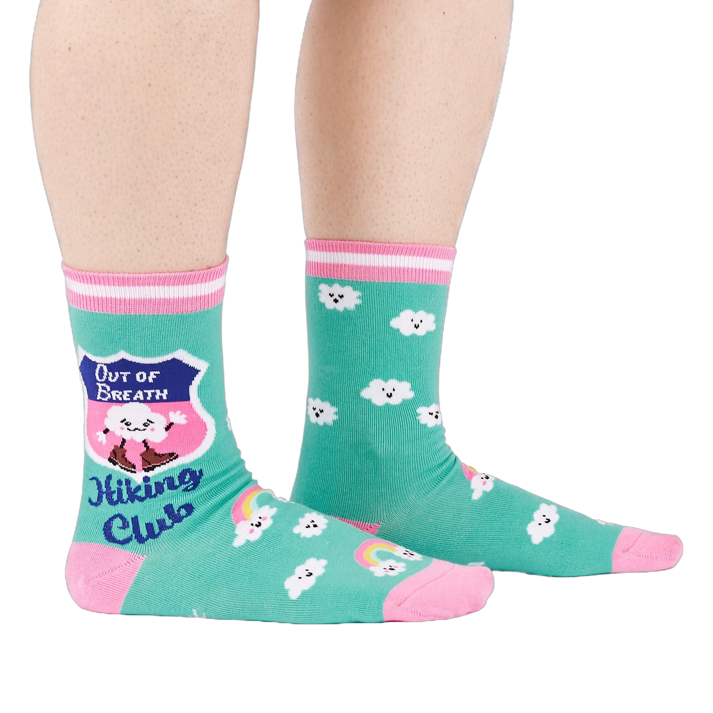 A person's legs wearing teal 'Hiking Club' crew socks, posed on a white background. Left sock shows shield design.