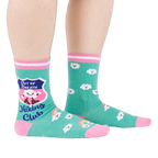 A person's legs wearing teal 'Hiking Club' crew socks, posed on a white background. Left sock shows shield design.