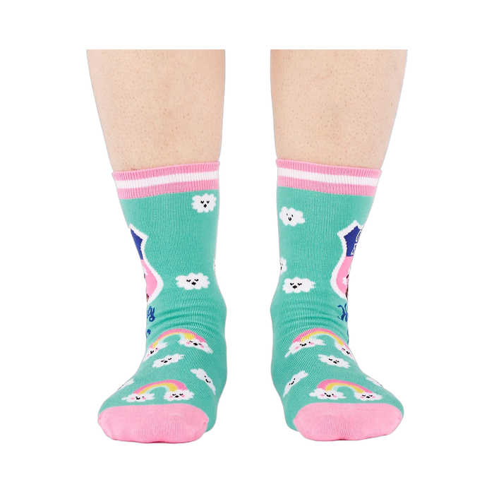 Front view of a person's legs wearing teal 'Hiking Club' crew socks. Both socks display the cloud pattern and 'Out of Breath' text.