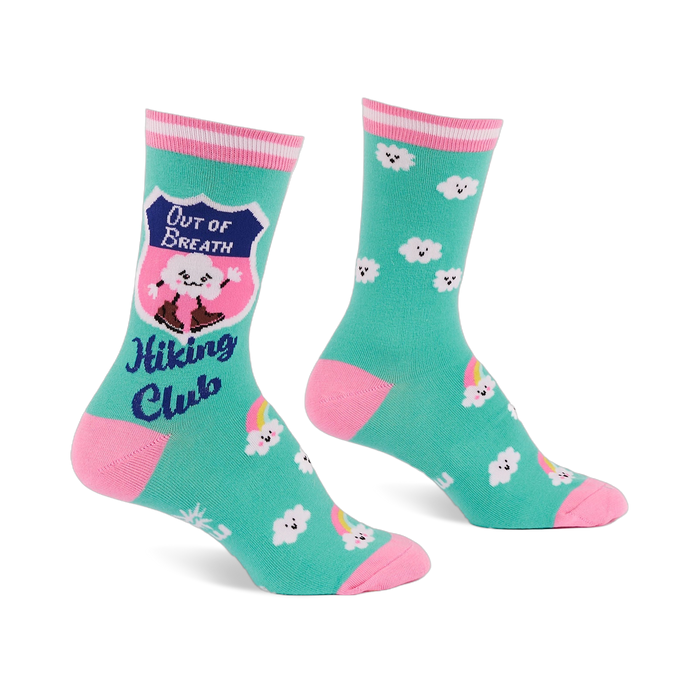 Pair of teal crew socks with pink toes, heels, and striped cuffs. Features a cloud in hiking boots, smiling white clouds, and rainbows.
