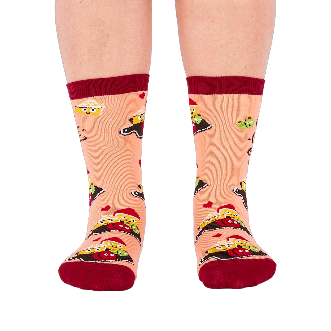Person wearing peach "Char-cute-erie" socks, shown from the front. Socks display smiling food characters on dark boards, red hearts, and dark red cuffs, heels, and toes.
