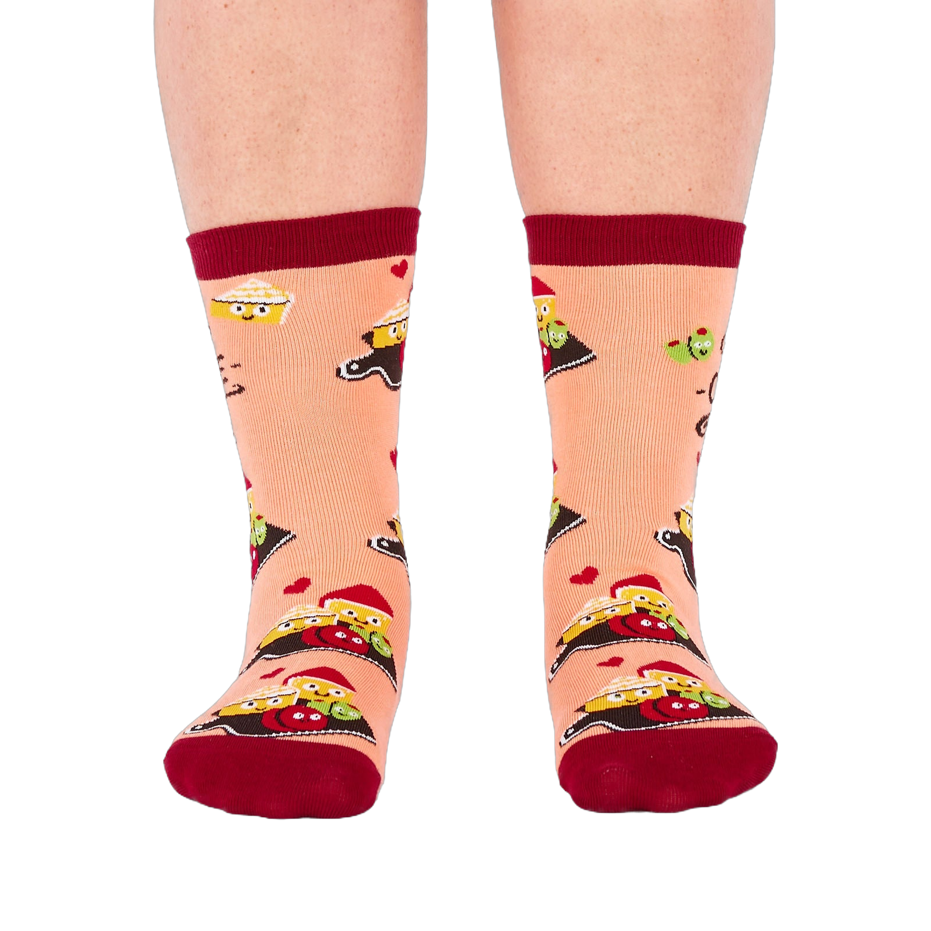 Person wearing peach "Char-cute-erie" socks, shown from the front. Socks display smiling food characters on dark boards, red hearts, and dark red cuffs, heels, and toes.
