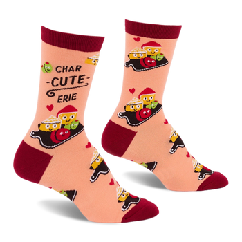 Pair of peach crew socks with dark red cuffs, heels, and toes, featuring a "Char-cute-erie" pattern of smiling cheese, olives, and red foods on boards, with small red hearts.