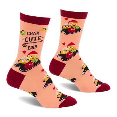 Pair of peach crew socks with dark red cuffs, heels, and toes, featuring a "Char-cute-erie" pattern of smiling cheese, olives, and red foods on boards, with small red hearts.