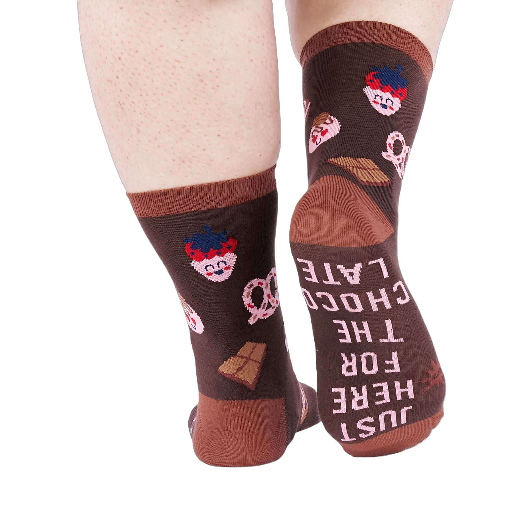 View from behind of person wearing chocolate pattern socks. The sole of one sock says "JUST HERE FOR THE CHOCOLATE".