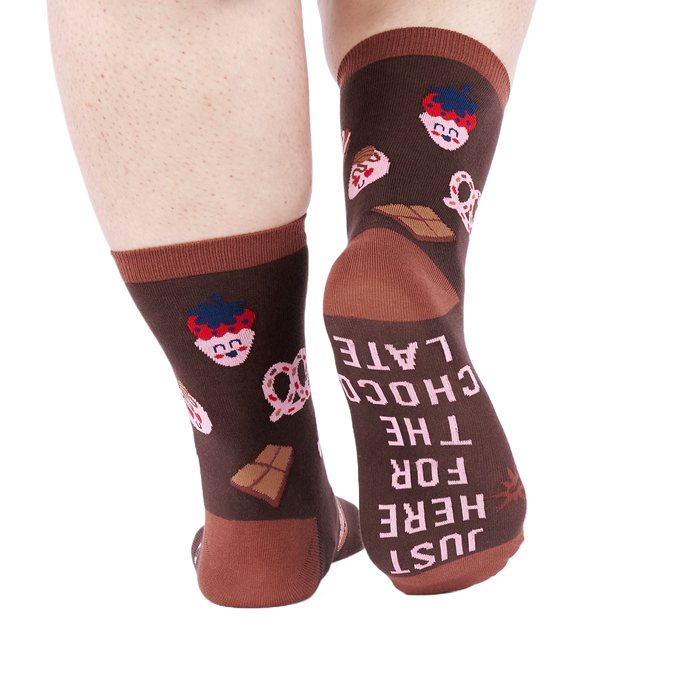 View from behind of person wearing chocolate pattern socks. The sole of one sock says 