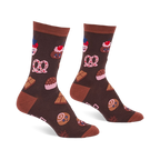 Pair of brown crew socks with light brown cuffs, heels, and toes, covered in a pattern of cupcakes, pretzels, and chocolate.