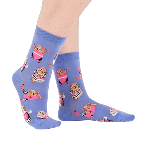 Person's feet wearing periwinkle crew socks with a guinea pig workout pattern, viewed from the side on white.