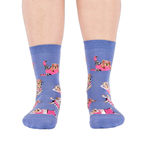 Person's feet wearing periwinkle crew socks with a guinea pig workout pattern, viewed from the front on white.