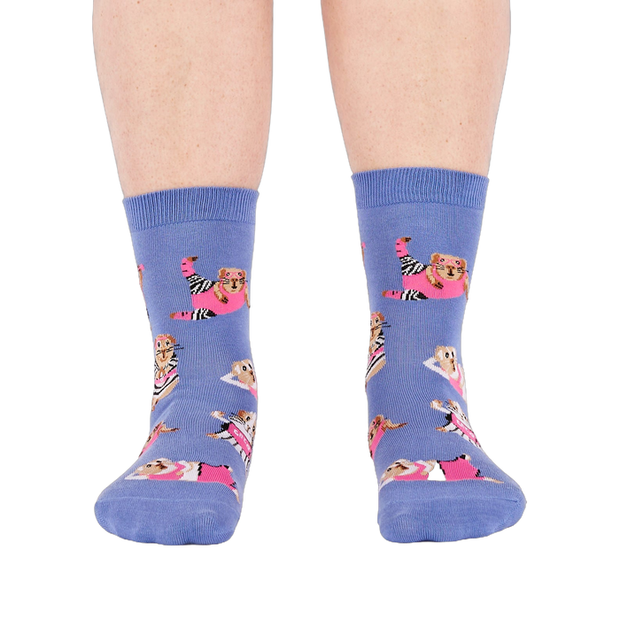 Person's feet wearing periwinkle crew socks with a guinea pig workout pattern, viewed from the front on white.