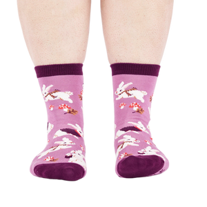 Person wearing the lavender 'Snuggle Bunny' crew socks, viewed from the front, showing leg and foot.