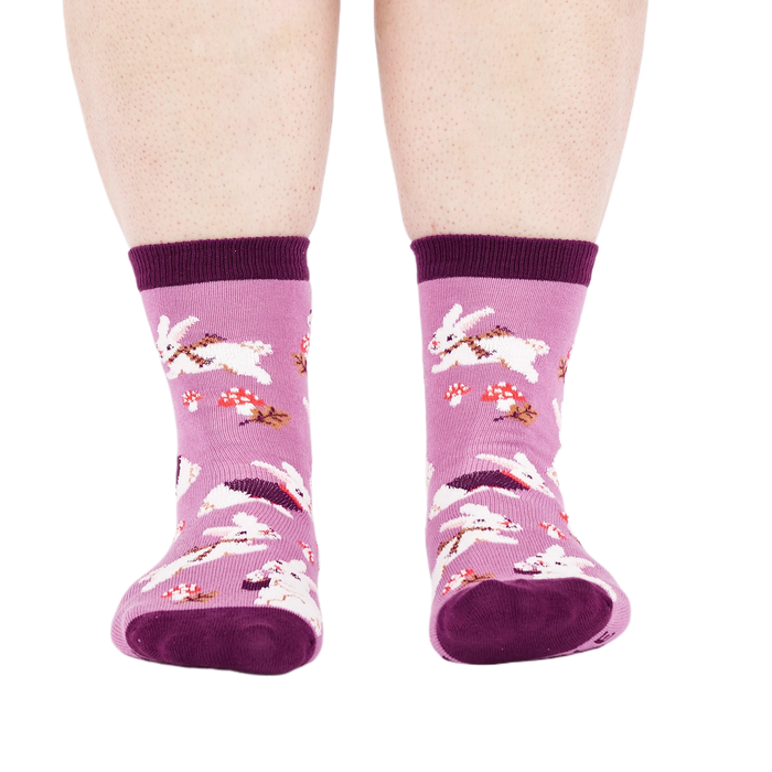 Person wearing the lavender 'Snuggle Bunny' crew socks, viewed from the front, showing leg and foot.