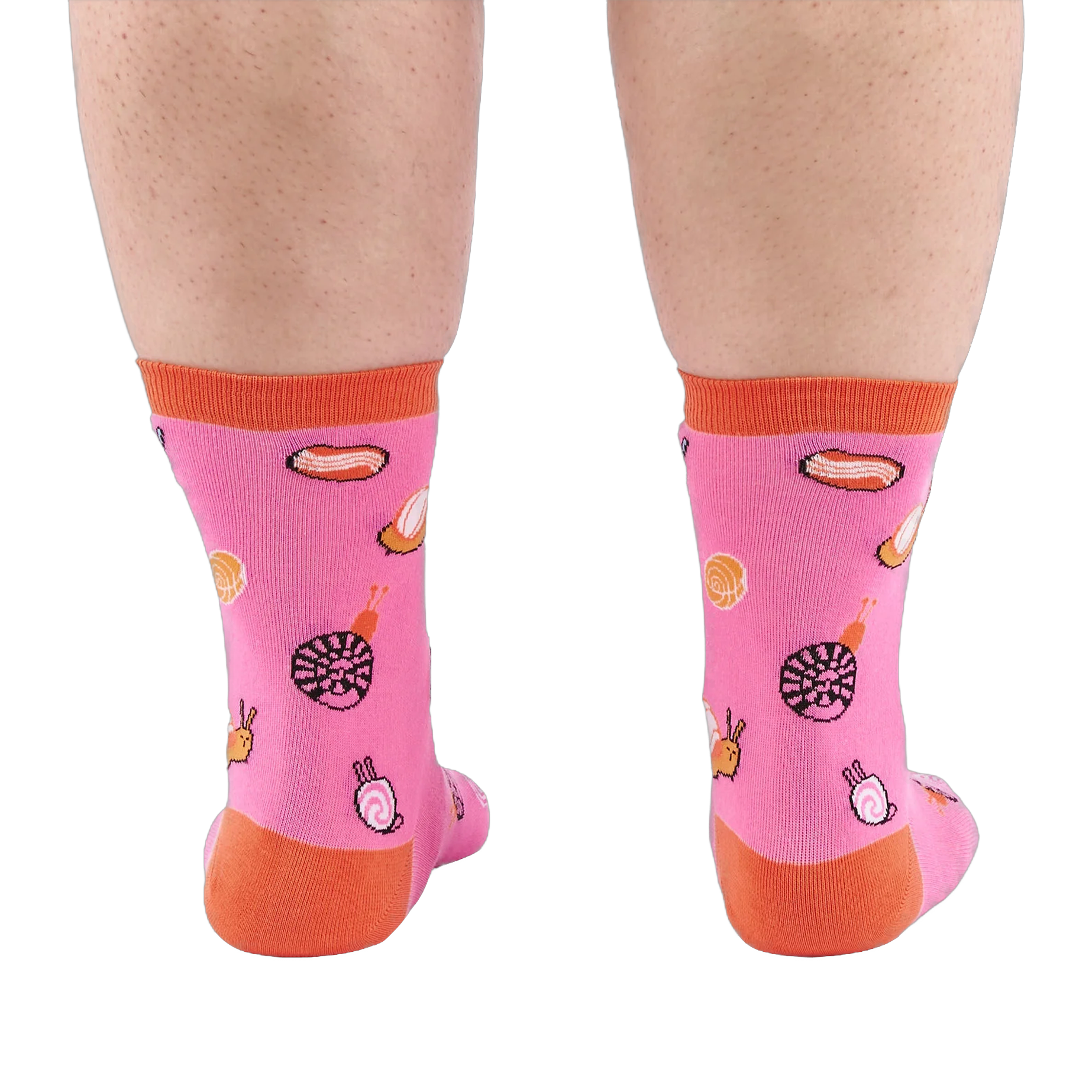 Back view of someone's calves wearing pink socks with jelly candy snails, candy swirls, and contrasting orange heels.