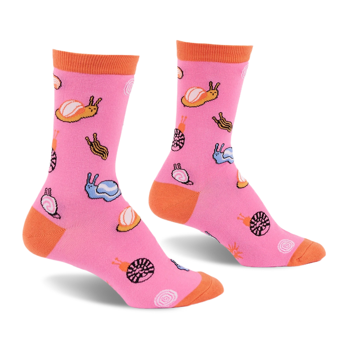 Bright pink crew socks featuring a pattern of colorful jelly candy snails and candy swirls with an orange cuff, heel, and toe.