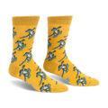 Yellow crew socks featuring a repeating pattern of green alligators doing tricks on bright blue skateboards.