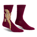 Burgundy crew socks with a large tan and yellow bearded dragon climbing up the outer side and a long tail pointing down.