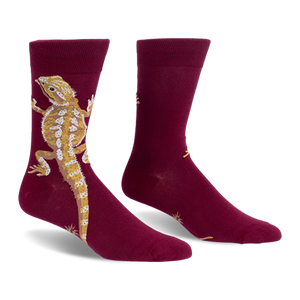 Burgundy crew socks with a large tan and yellow bearded dragon climbing up the outer side and a long tail pointing down.