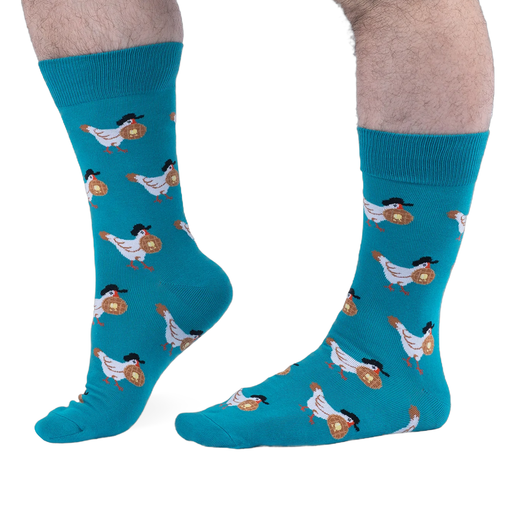 Person with hairy legs wearing bright teal crew socks that feature a pattern of white chickens carrying buttered waffles.