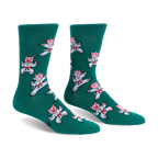 Pair of green crew socks featuring a pattern of pink pigs wearing white karate uniforms and red belts in martial arts poses.
