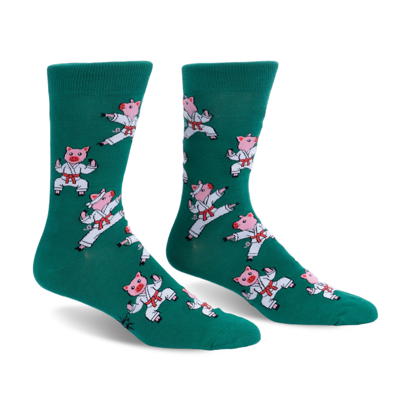 Pair of green crew socks featuring a pattern of pink pigs wearing white karate uniforms and red belts in martial arts poses.