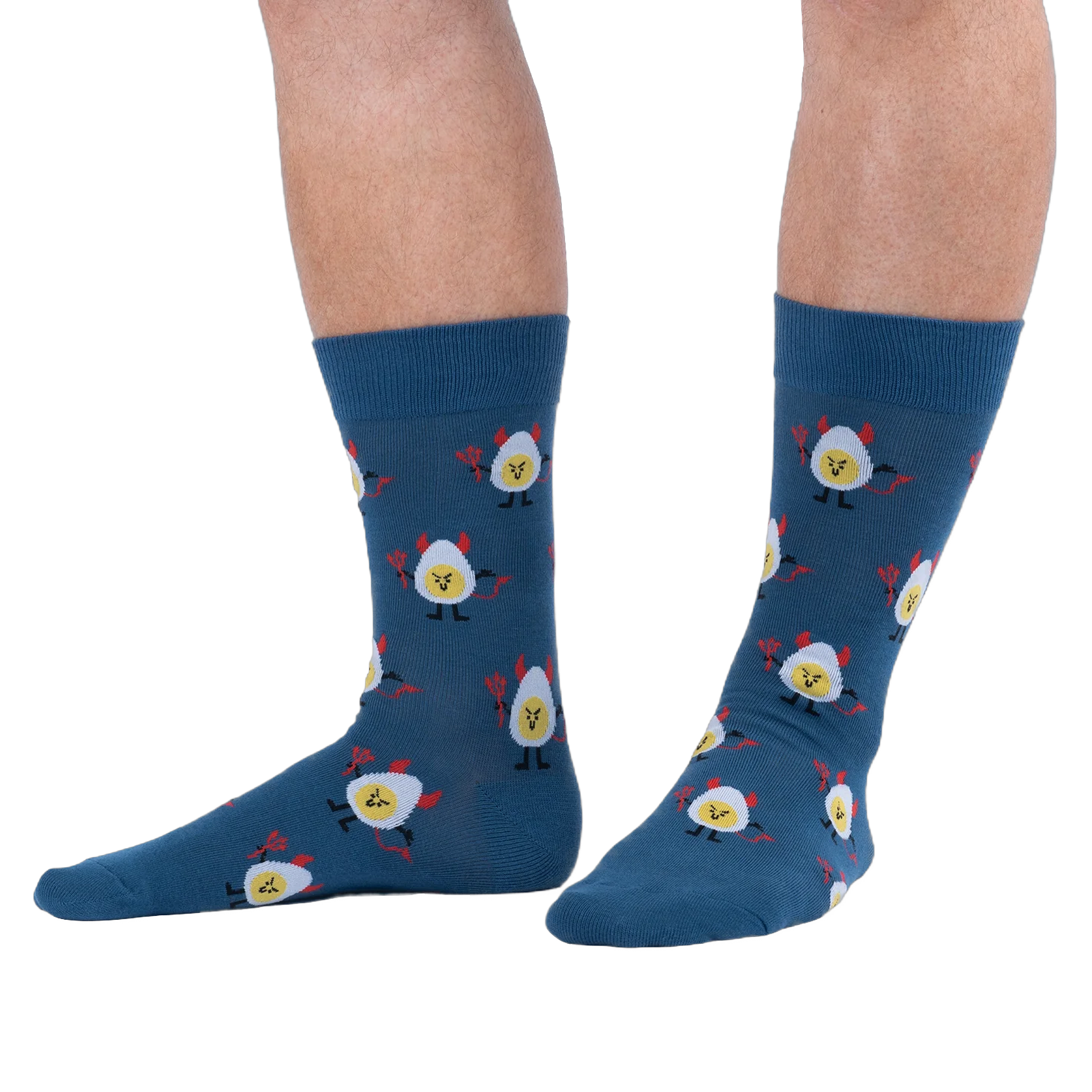 Lifestyle shot of a person wearing dark blue crew socks with a deviled egg pattern against a solid black background.
