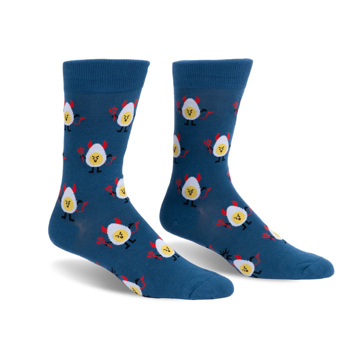 Dark blue crew socks with a repeating pattern of deviled eggs featuring yellow faces, red devil horns, tails and pitchforks.