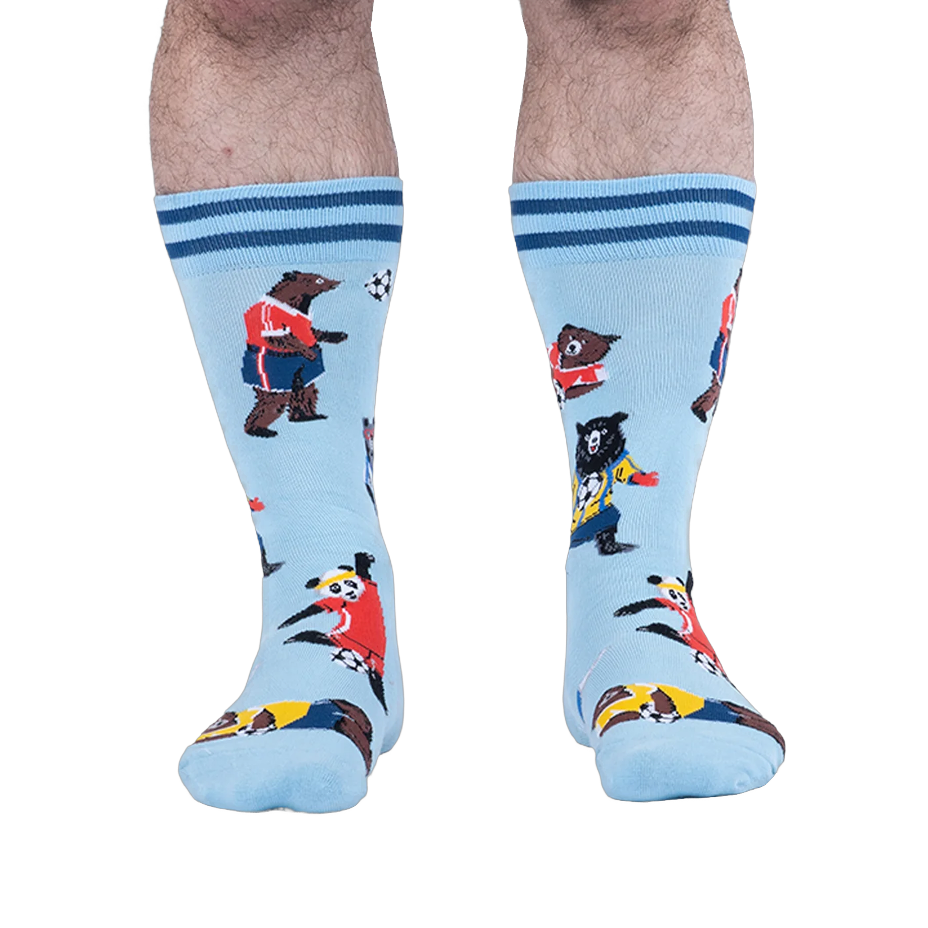 Front view of light blue socks on a person, showing a panda in a red jersey kicking a soccer ball among other playing bears.