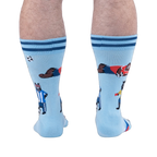 Back view of the socks worn on legs, highlighting a bear in a blue and white striped jersey standing with a soccer ball.